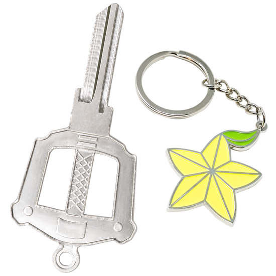 A silver house key next to a yellow and bright green keychain depicting a fruit inspired by the Kingdom Hearts series