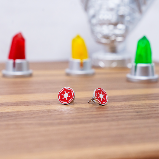A pair of red earrings featuring the Empore logo from Star Wars in front of green, yellow and red Kyber crystals
