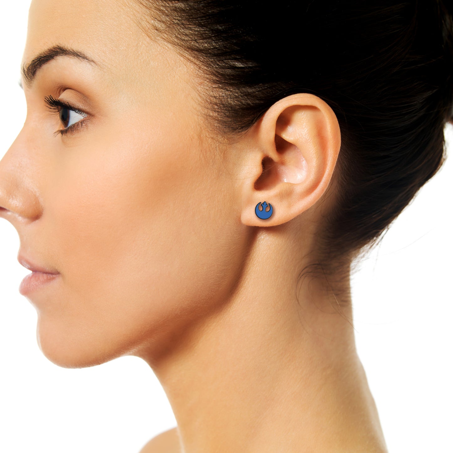 A woman with dark brown hair wearing an earring featuring the rebel icon from Star Wars